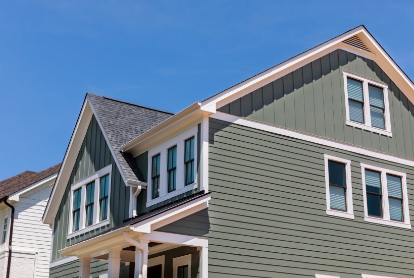 Side view of residential home with green vinyl siding