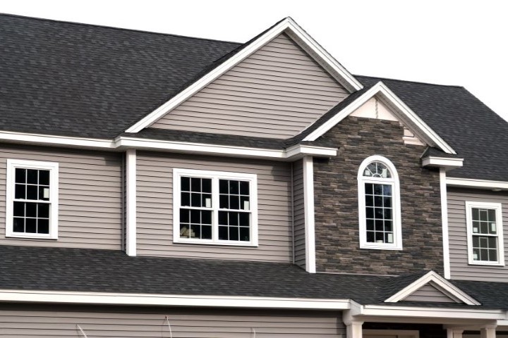 CCC Roofing employees working on a gray asphalt rooftop
